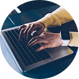 working on a laptop hands typing on laptop